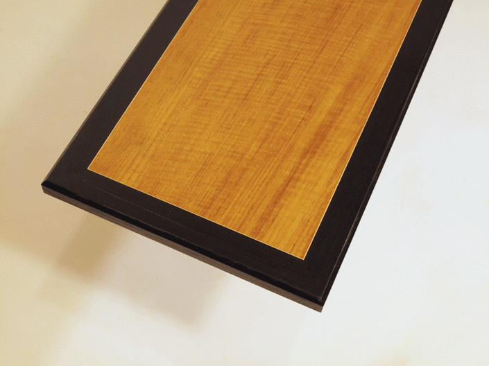 Photo of rectangular table with curly teak veneer and wenge rim