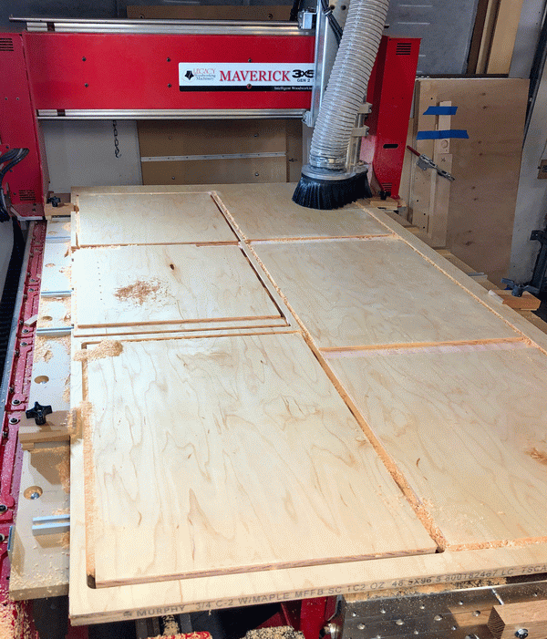 Photo of cabinet case parts being cut on CNC