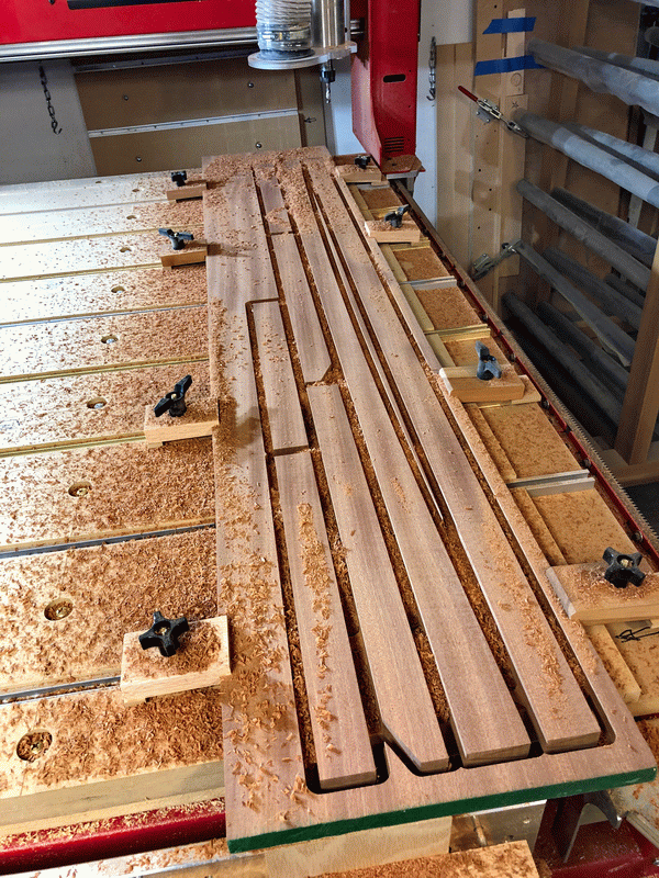 Photo of cabinet face frame solid wood parts being cut on CNC