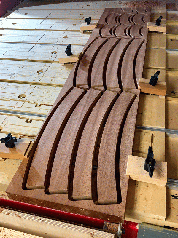 Photo of end table solid wood rim pieces being cut on CNC